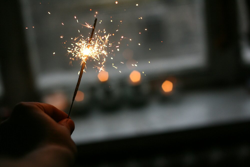Person holding a lit sparkler